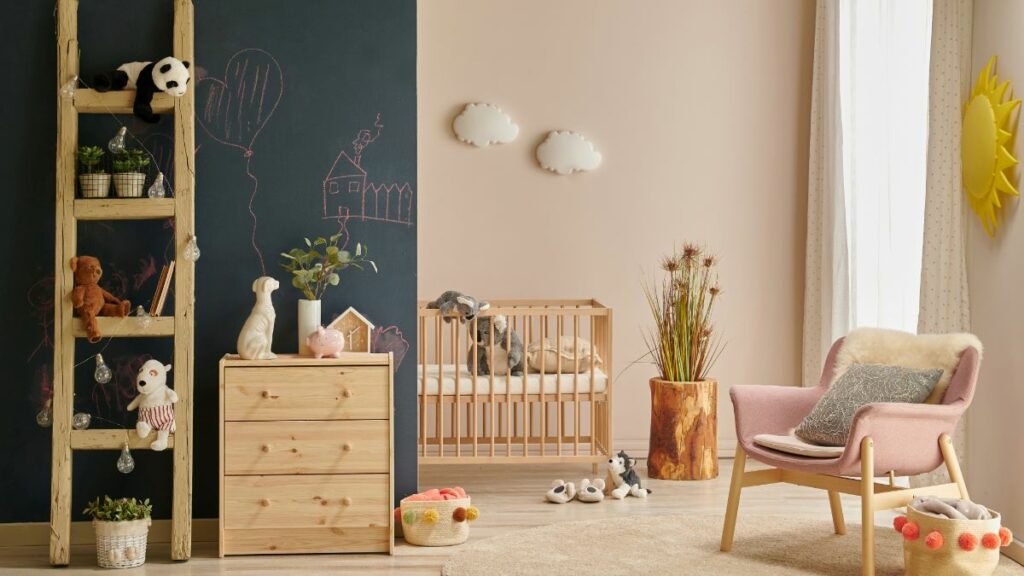 A calm and cozy peach decor baby nursery with a wooden crib, a dresser, and a neutral color scheme.
