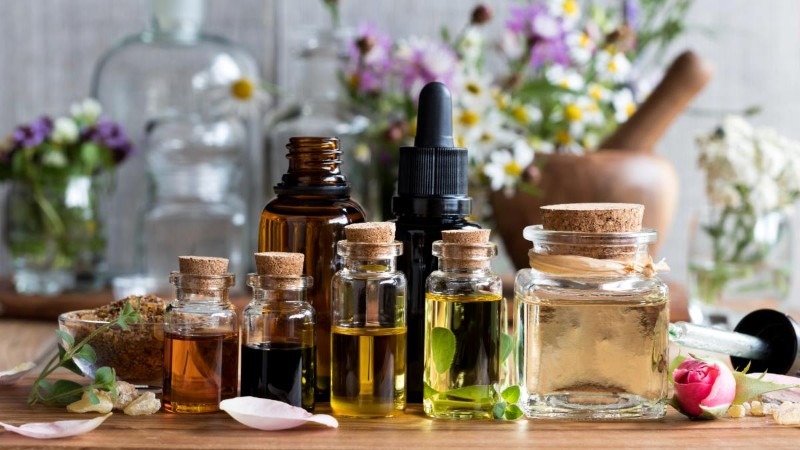 A collection of different essential oil bottles, a popular way to create custom scents in a diffuser and make your home smell amazing naturally.