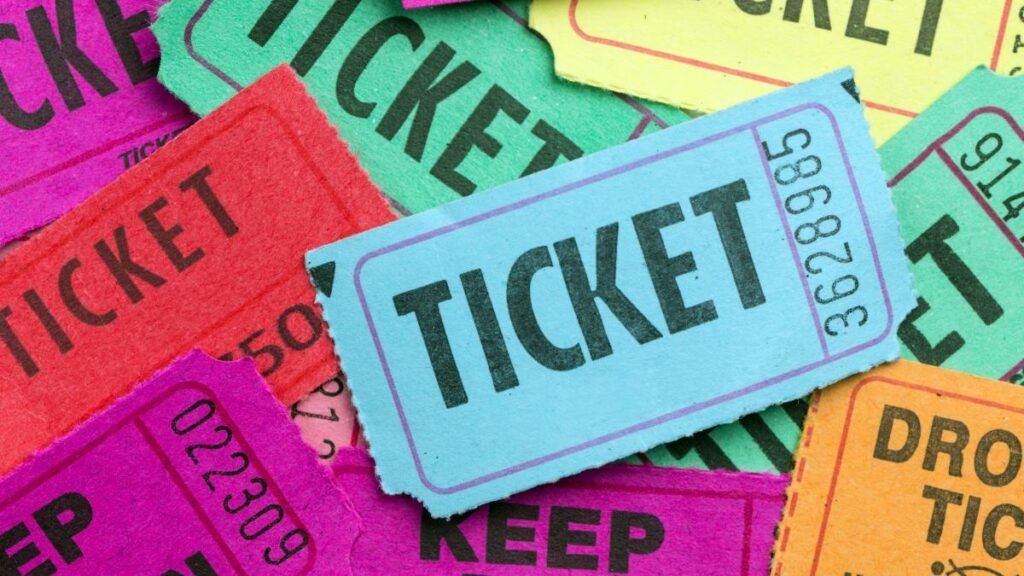 A pile of colorful raffle or event tickets in various colors as gift vouchers.