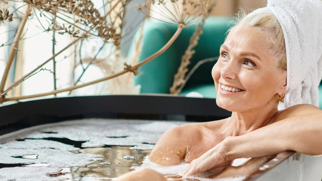 A mature woman relaxing in an outdoor hot tub, enjoying a moment of peace and self-care.