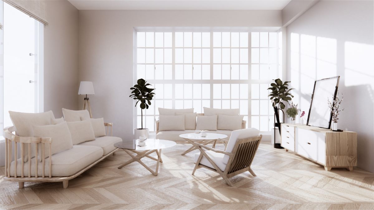 A bright and harmonious living room demonstrating the principles of feng shui interior design, with abundant natural light and green plants.