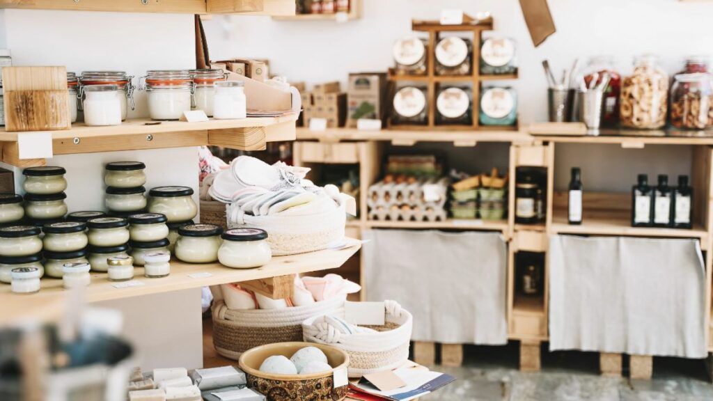 The interior of a charming boutique or artisan shop, with shelves displaying handmade candles, soaps, and other gifts for a modern minimalist.