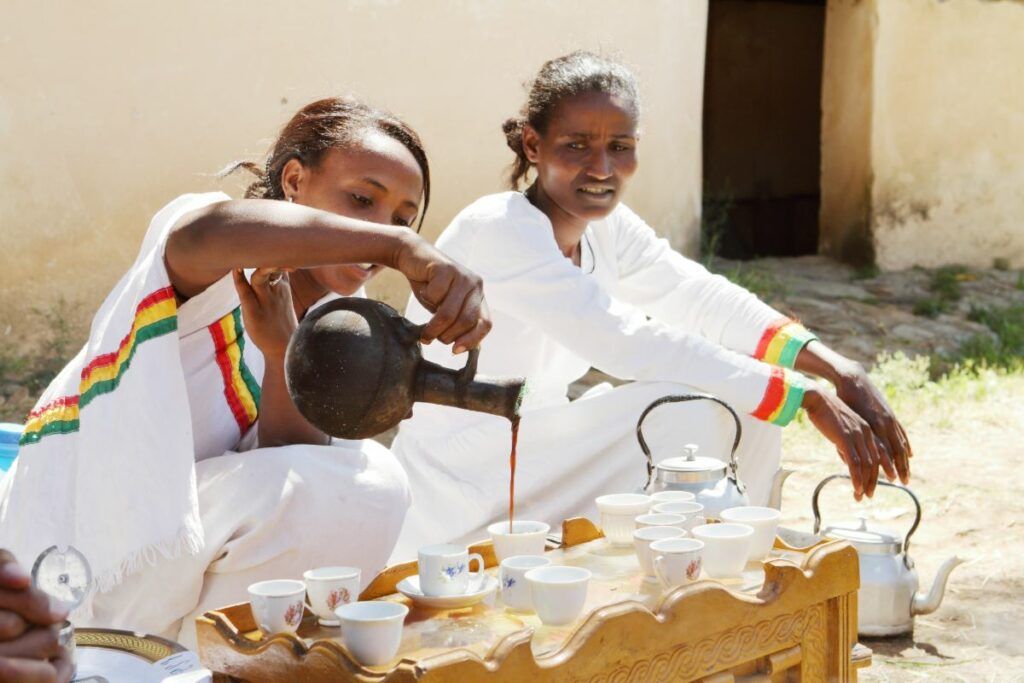 An elder performing a traditional Ethiopian coffee ceremony at a wedding, a significant cultural ritual in many African wedding celebrations.