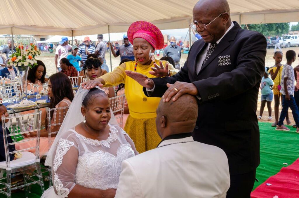 Elders giving a parental blessing to a bride and groom during a traditional African wedding ceremony, a deeply respected custom.