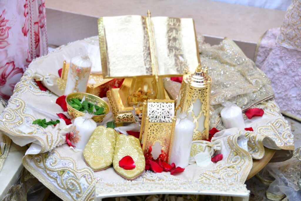 An elegant display of beautifully wrapped wedding gifts in gold and white, a common sight at Muslim wedding receptions.