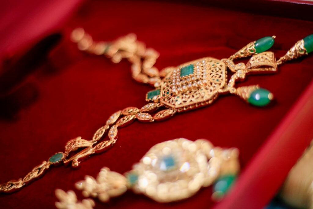 An opulent gold jewelry set with green gemstones, a classic and valuable wedding gift for a Muslim bride, sometimes part of the dowry.