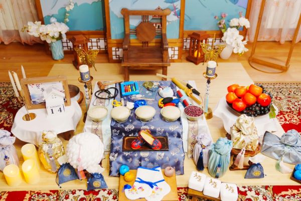 A traditional Korean first birthday celebration, or Doljanchi, showing a ceremonial table laden with symbolic foods like rice cakes and fruits for the baby.